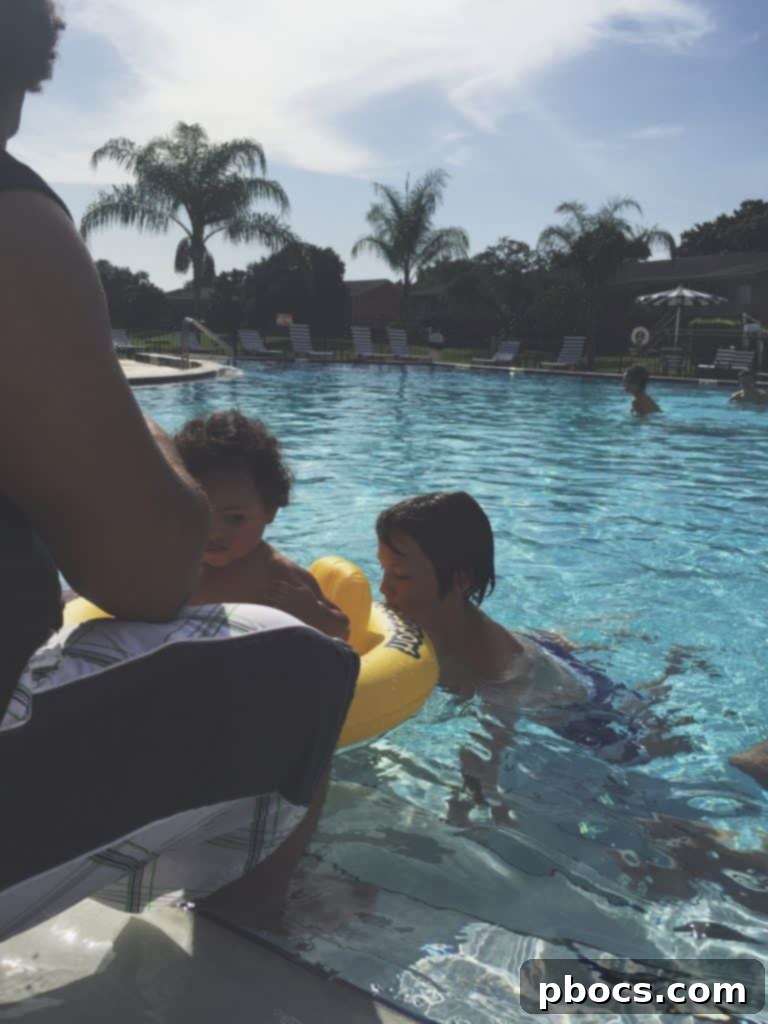 A family member expertly grilling food on a barbecue during a lively Fourth of July celebration at home.