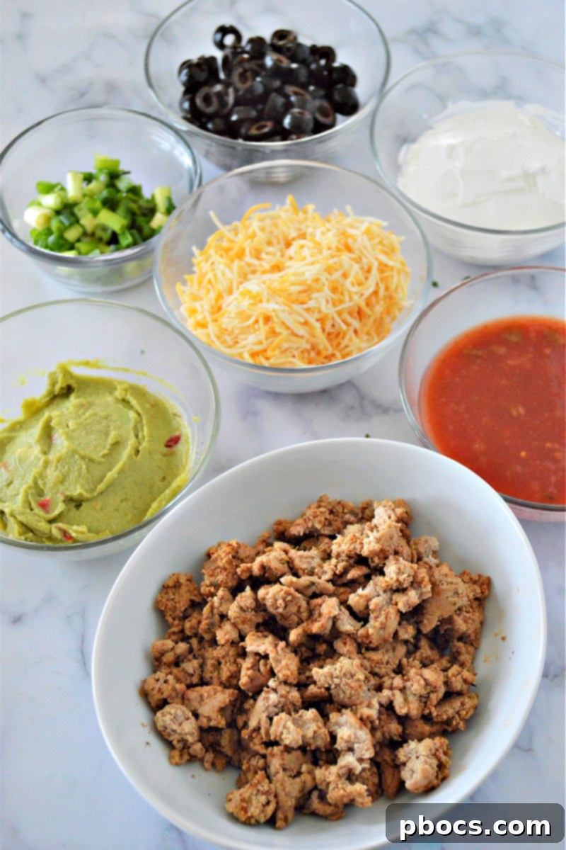 An overhead shot of the Low-Carb 7 Layer Taco Dip with a serving spoon, ready to be enjoyed.