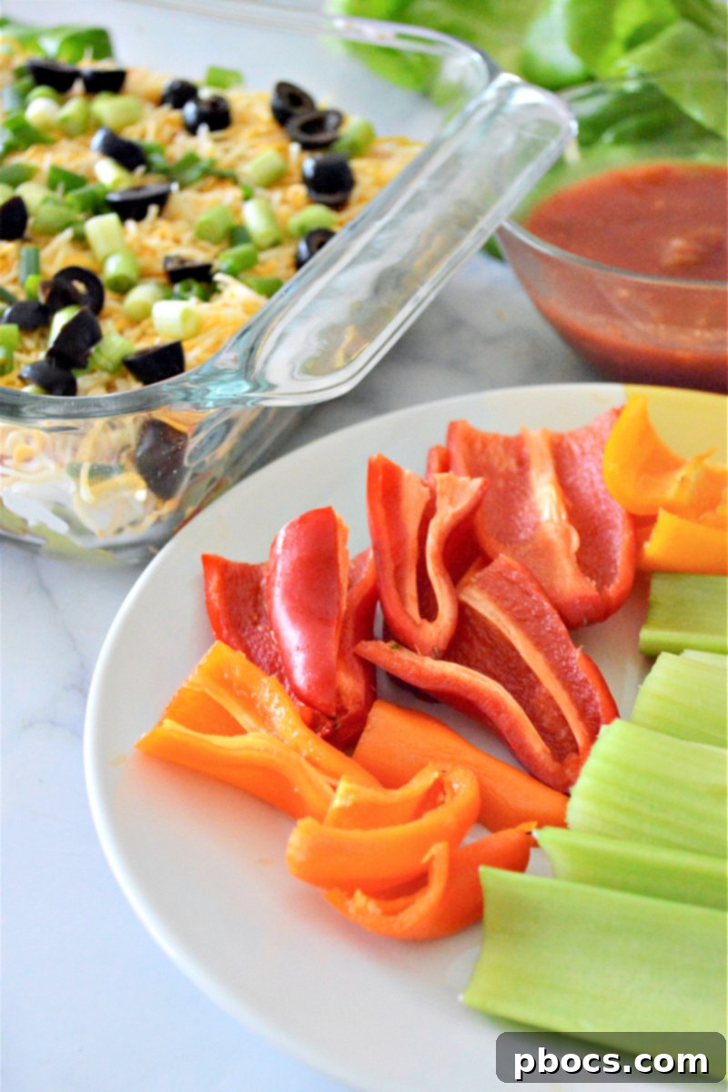 A fresh batch of Low-Carb 7 Layer Taco Dip, garnished and ready to serve.