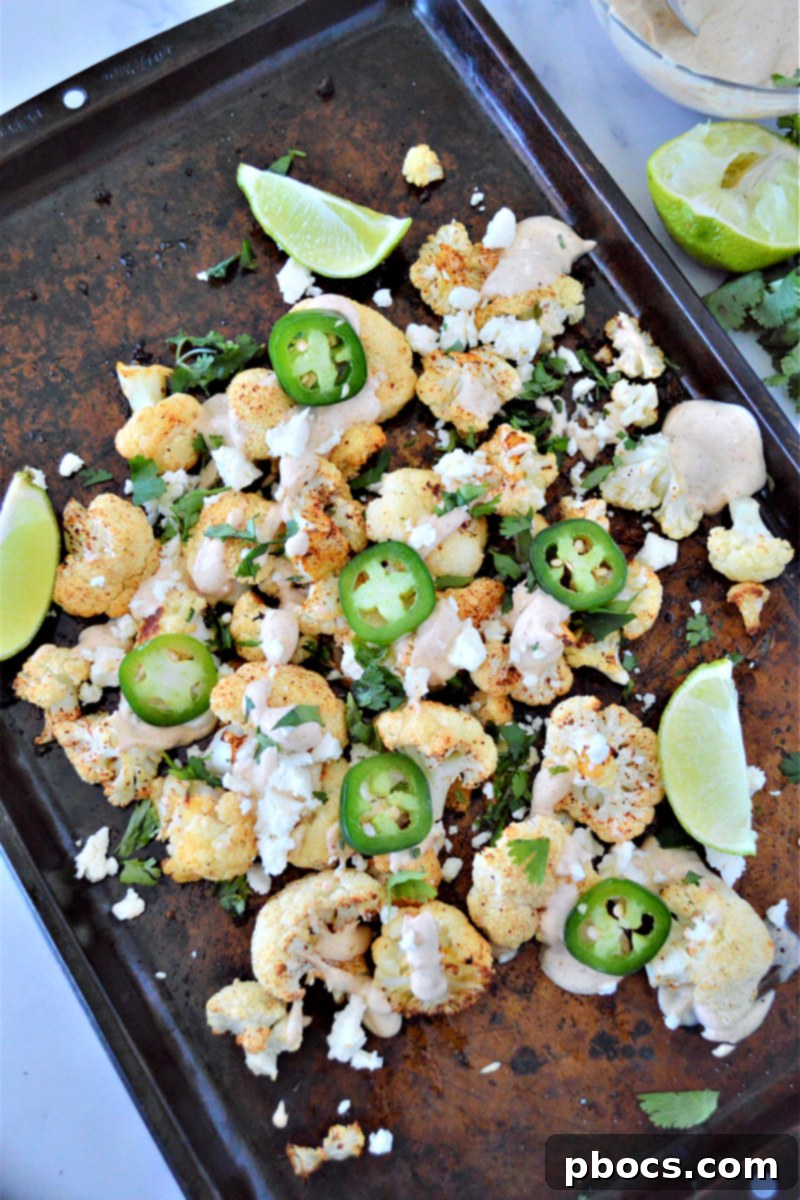 Keto Mexican Street Cauliflower – Roasted cauliflower florets seasoned with Mexican spices, drizzled with a creamy lime sauce, and topped with cotija cheese and cilantro.
