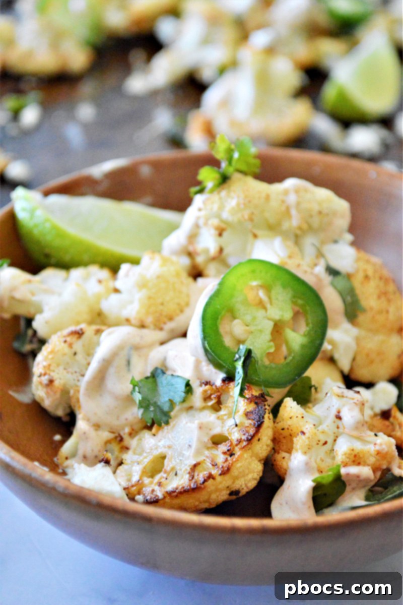 Close-up of roasted Keto Mexican Street Cauliflower with visible chili powder, cumin, and fresh cilantro.