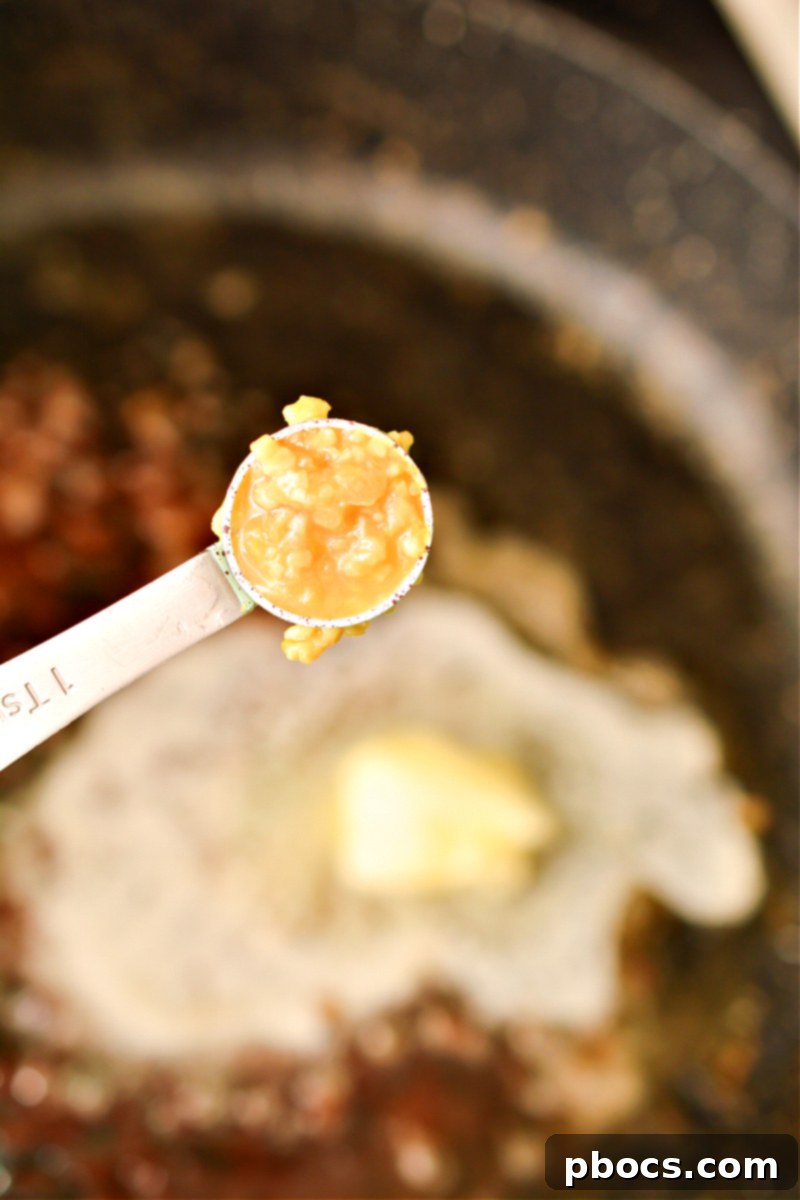 Effortless Keto Shrimp Scampi 12 Adding garlic and butter to skillet for scampi sauce