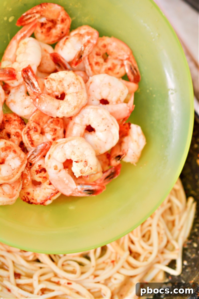 Effortless Keto Shrimp Scampi 15 Returning shrimp to scampi sauce and noodles