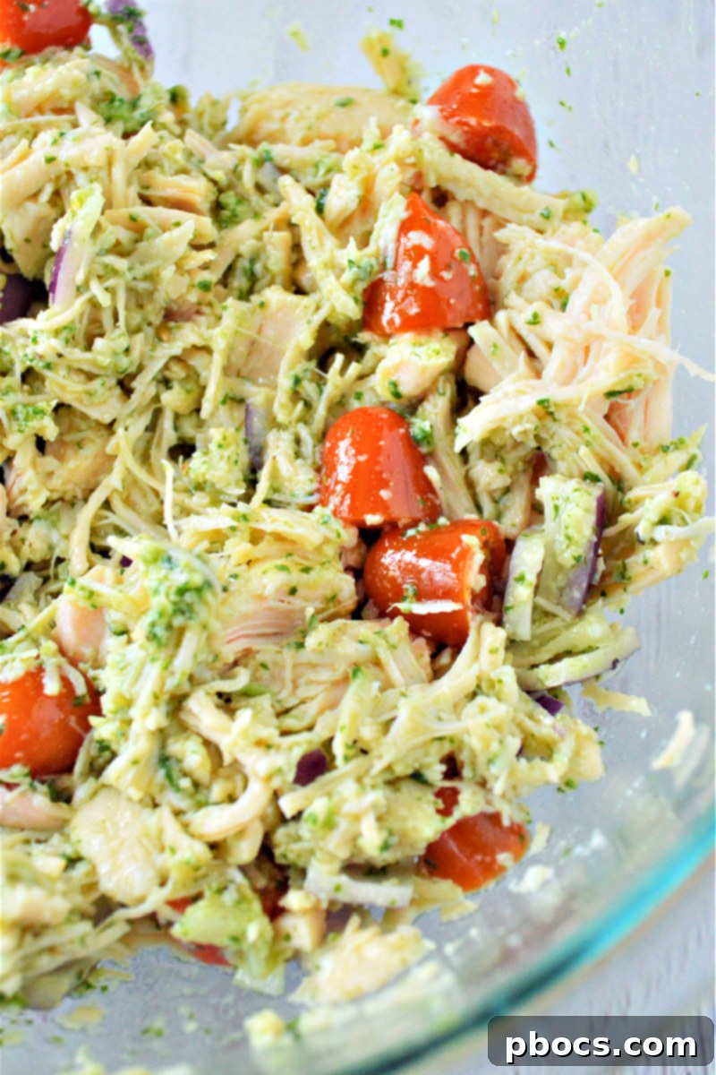 Mediterranean Low Carb Pesto Chicken Salad 13 Tossing ingredients for a well-combined pesto chicken salad