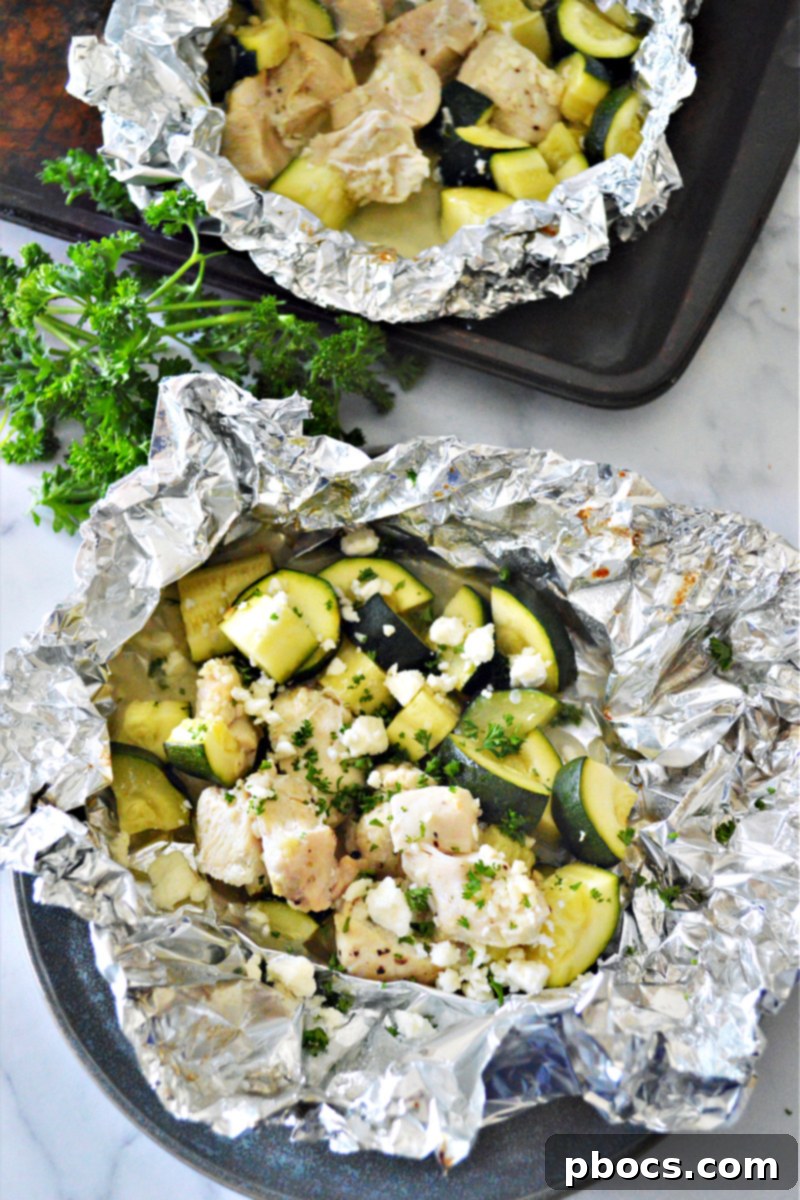 Garlic Butter Chicken Foil Packets - Tender chicken and zucchini cooked in individual foil packets with garlic butter