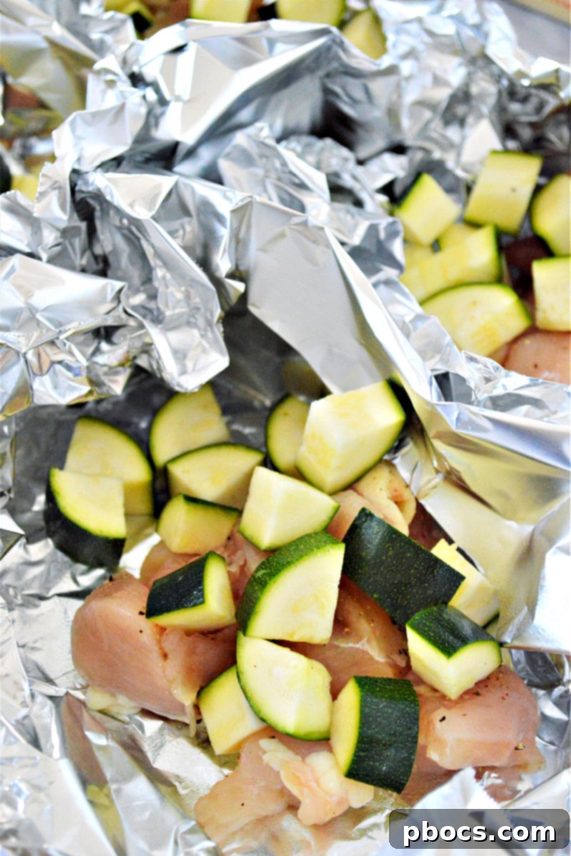 Step 4: Chicken and zucchini placed in foil boats for cooking