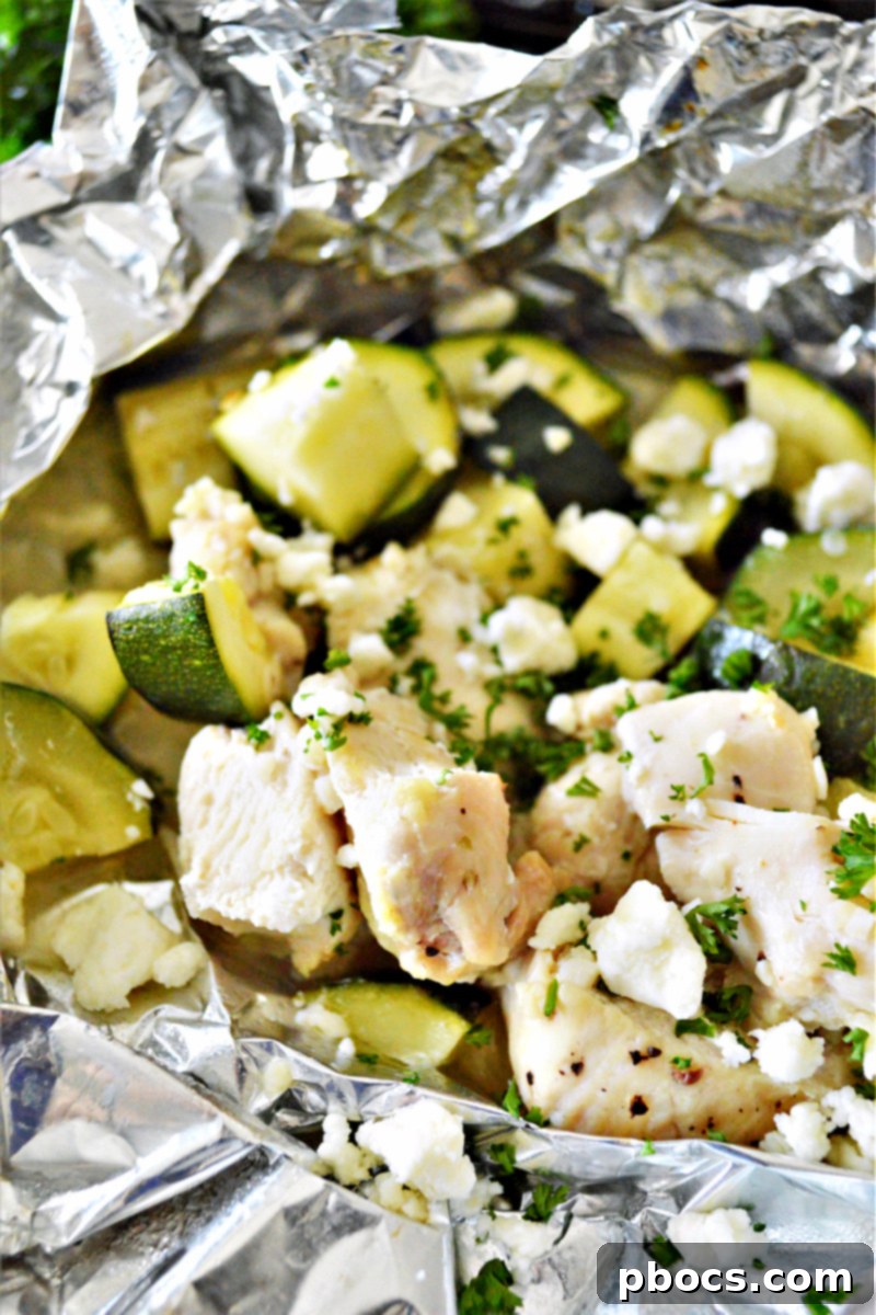 Garlic Butter Chicken Foil Packets cooking on an outdoor grill for a summer keto meal