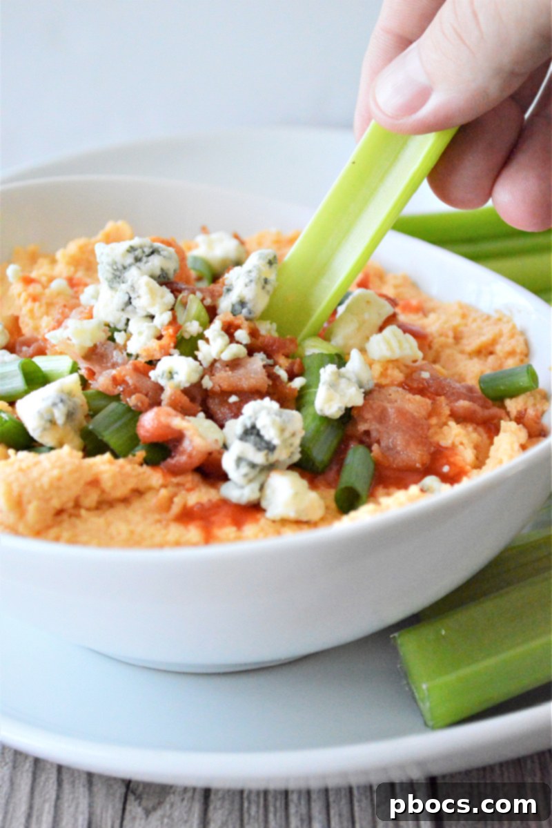 Buffalo Cauliflower Hummus Garnished with Blue Cheese and Green Onions