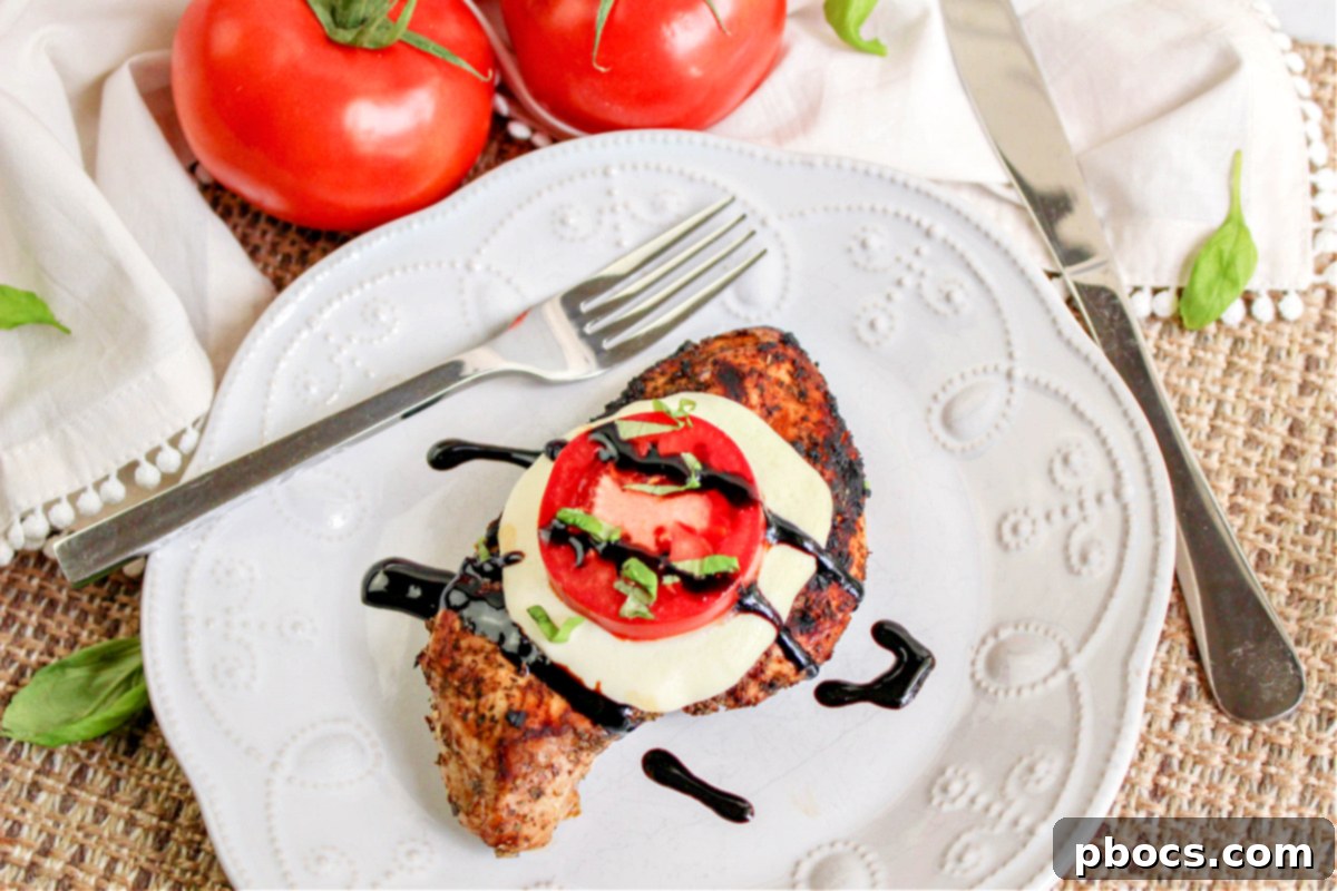 Keto Caprese Chicken Bake 3 Close-up of grilled Caprese chicken with melted mozzarella, sliced tomatoes, and basil
