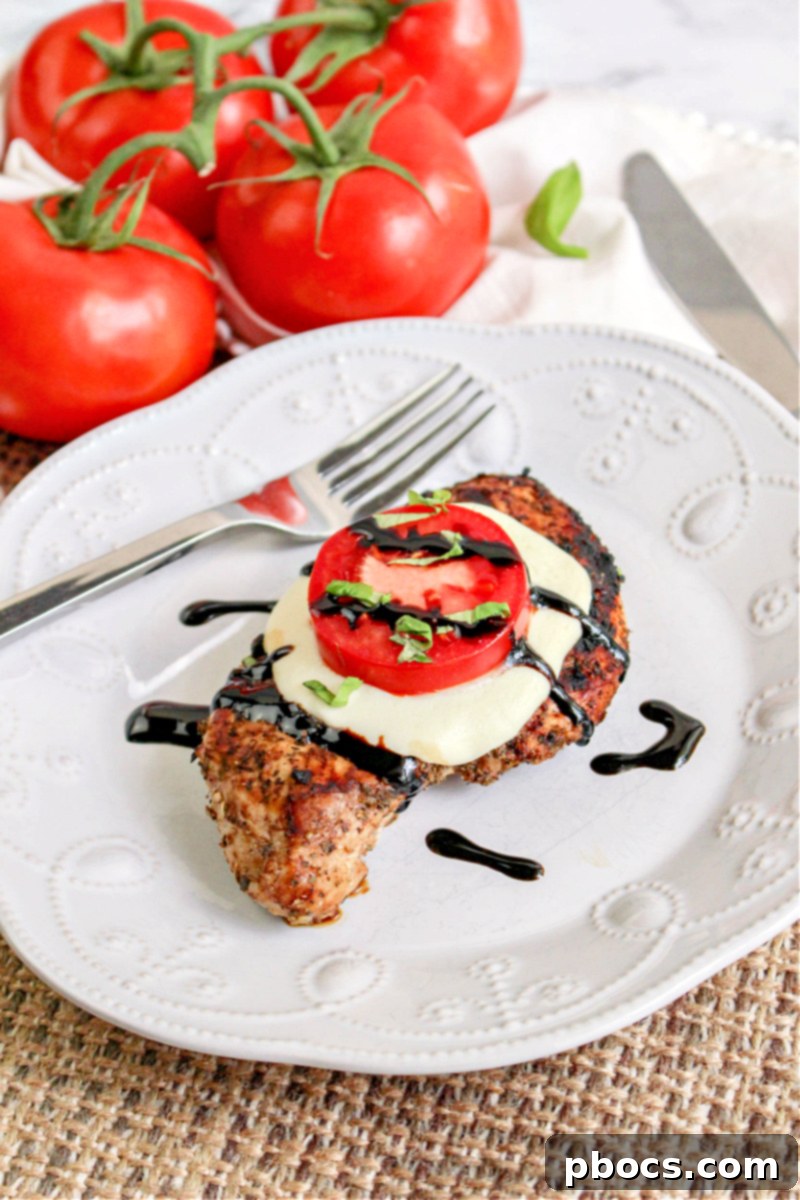 Keto Caprese Chicken Bake 4 Keto Caprese Chicken served on a white plate, highlighting the fresh ingredients