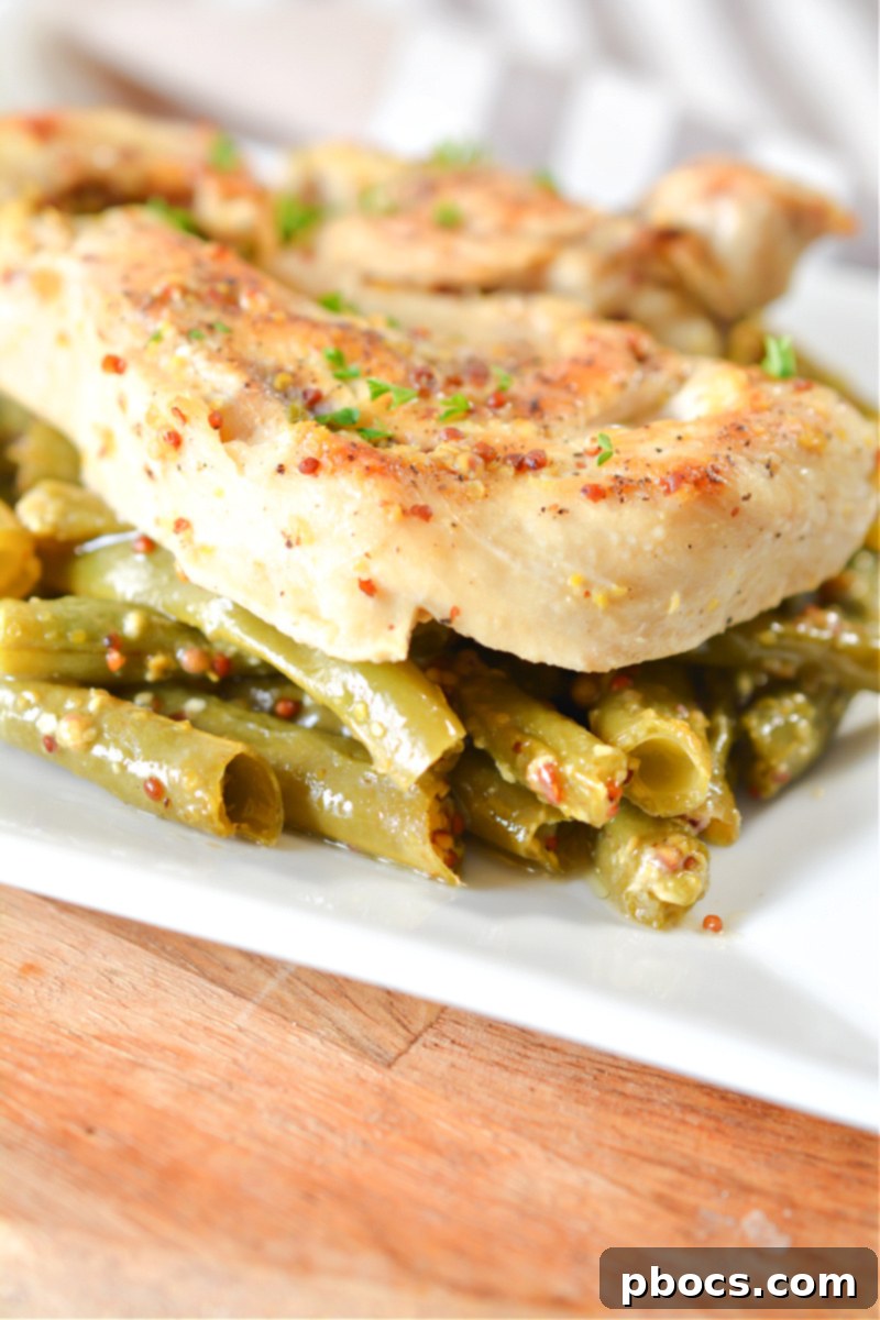 Portioned Keto Honey Mustard Chicken and green beans in meal prep containers, ready for the week.