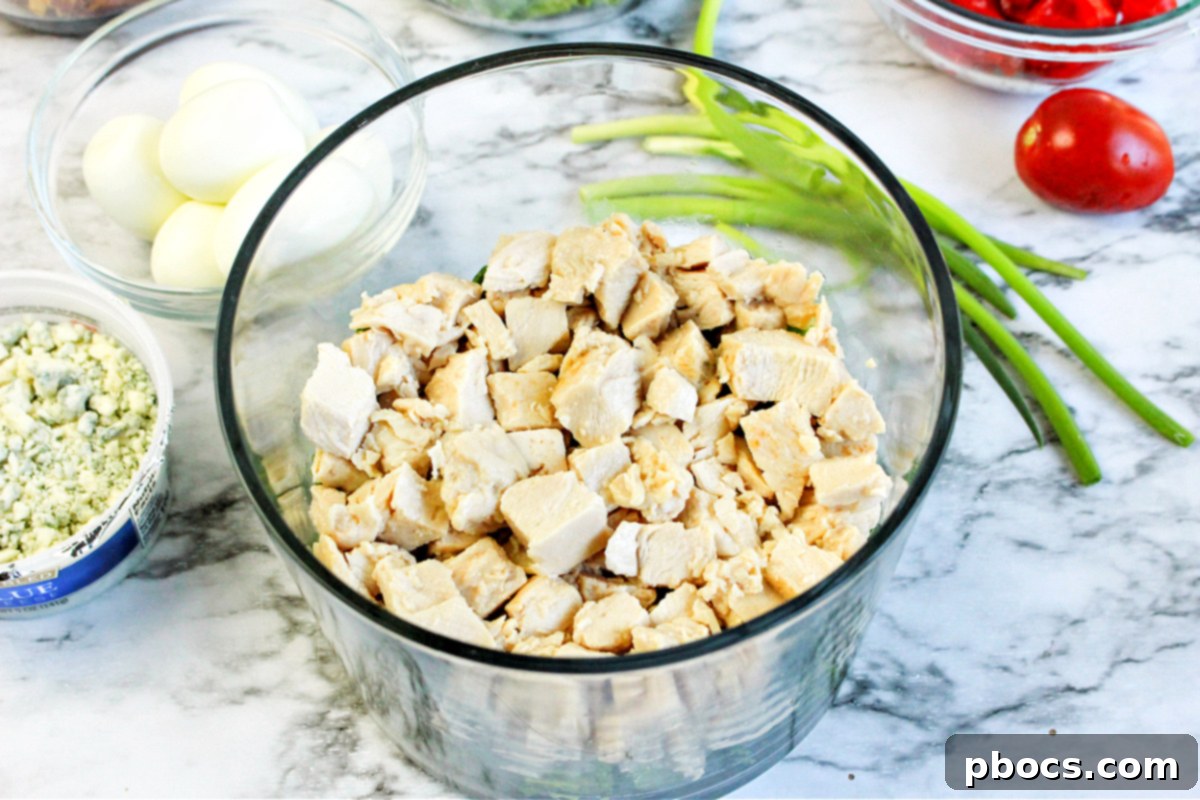 Smart Carb Chicken Cobb Trifle 13 Layering chicken and tomatoes in the trifle bowl