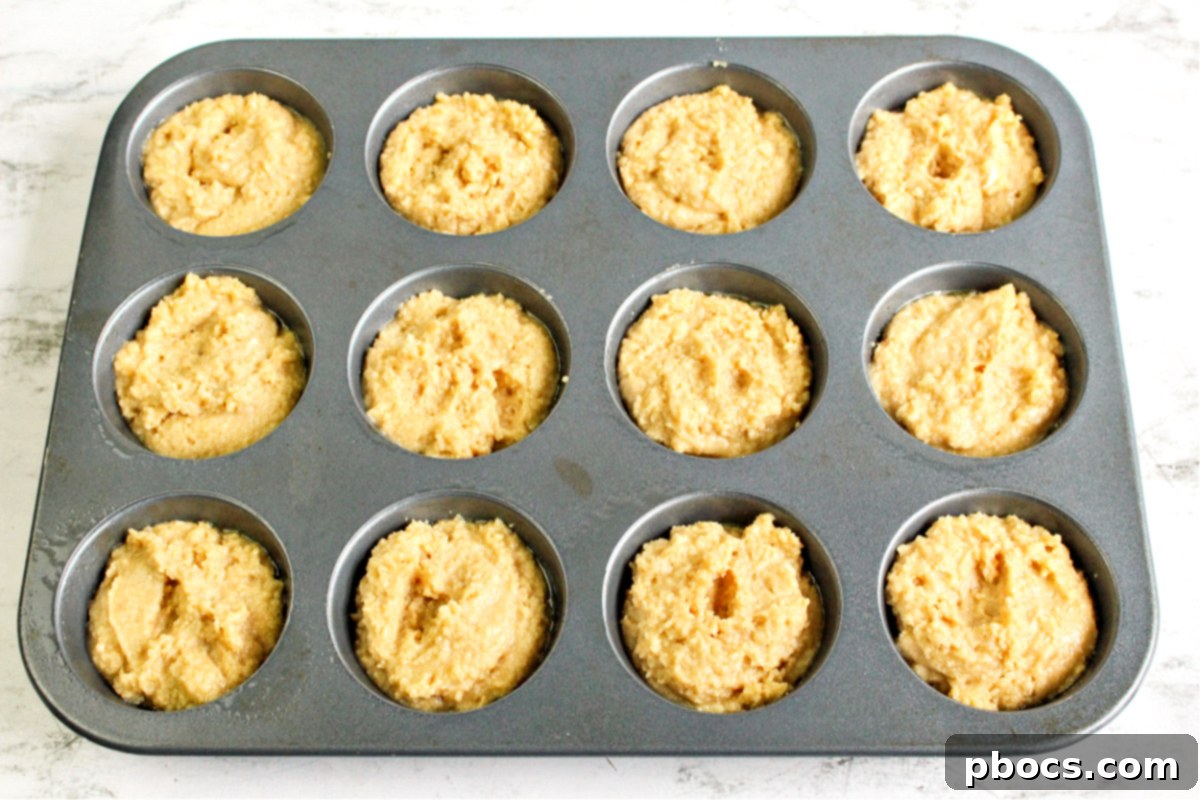 Dividing keto cake batter into muffin tins