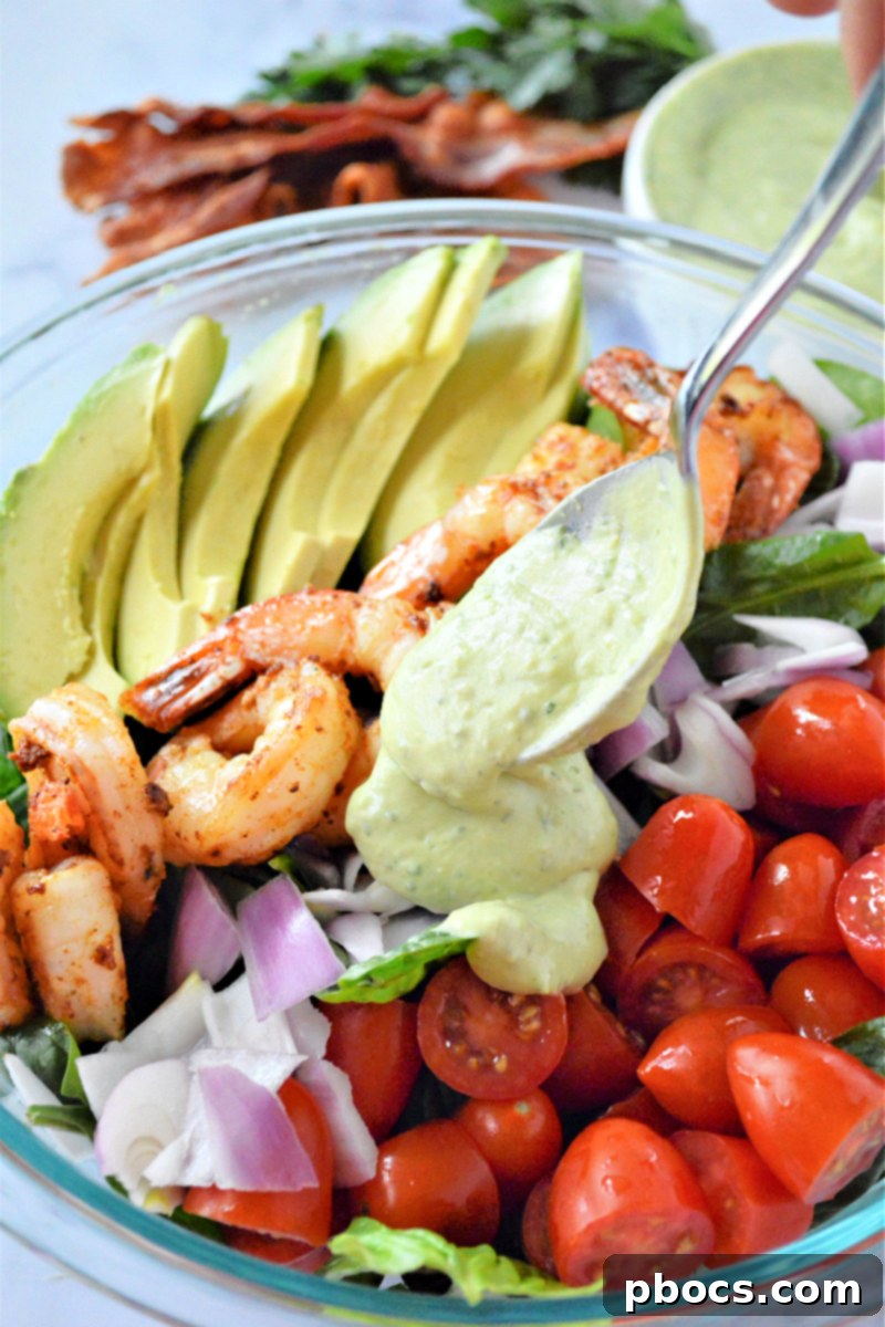 Step 8: Drizzling and tossing the salad with avocado ranch dressing.