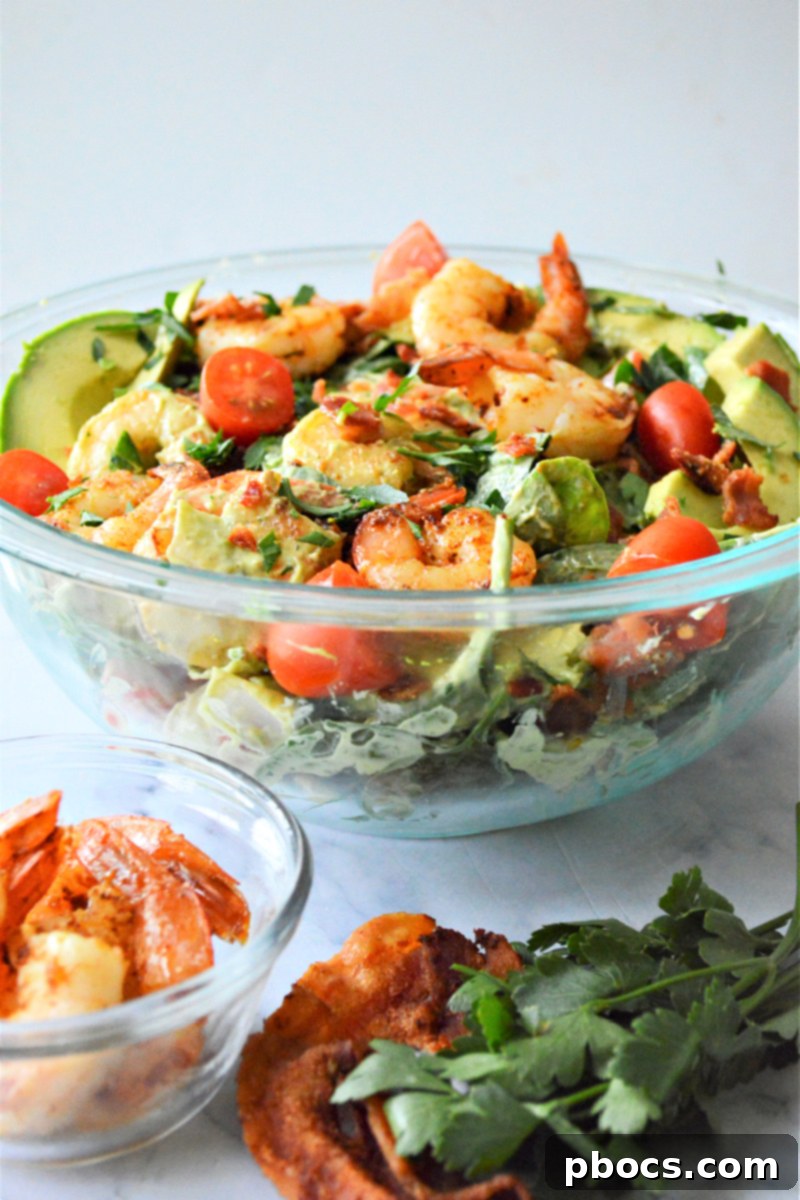 Step 9: Final presentation of Shrimp Avocado and Spinach Salad with toppings.