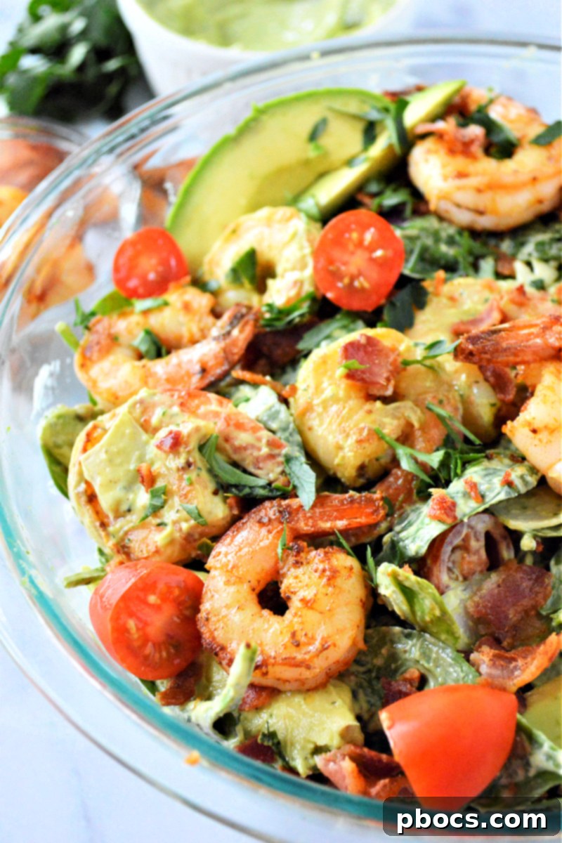 A refreshing summer salad featuring shrimp, avocado, and spinach, perfect for a light meal.