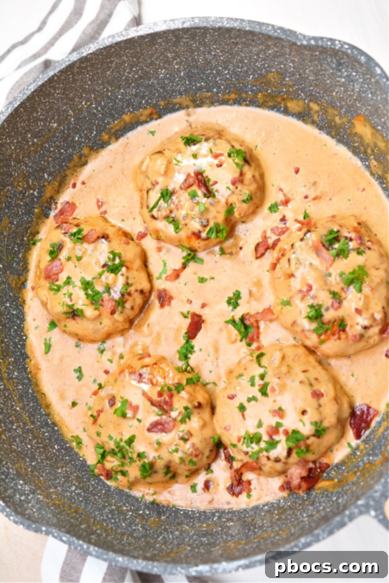 Keto Cheddar Ranch Chicken Burgers cooking in a skillet, sizzling beautifully