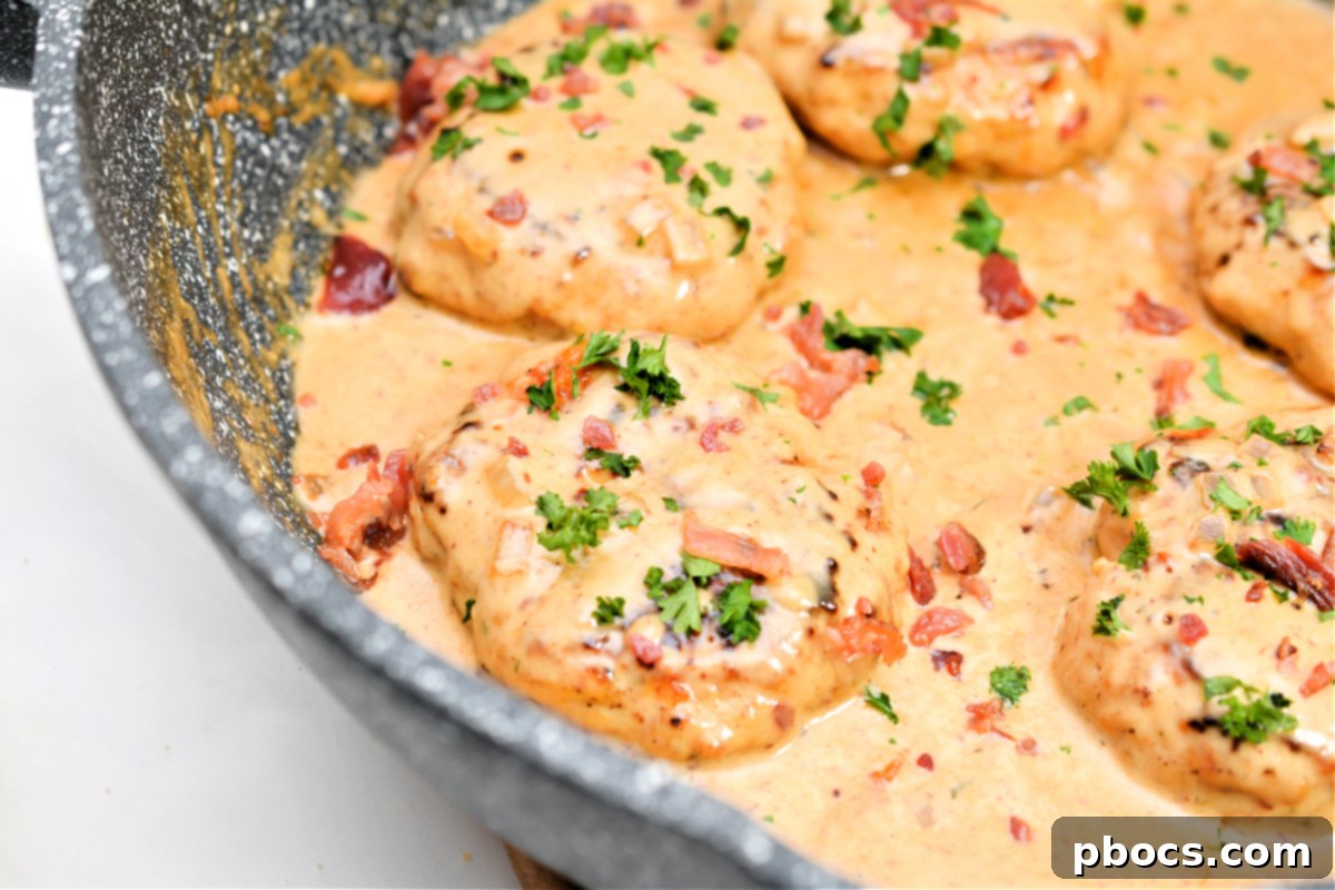 Keto Cheddar Ranch Chicken Burgers served in a skillet, coated in a creamy BBQ sauce