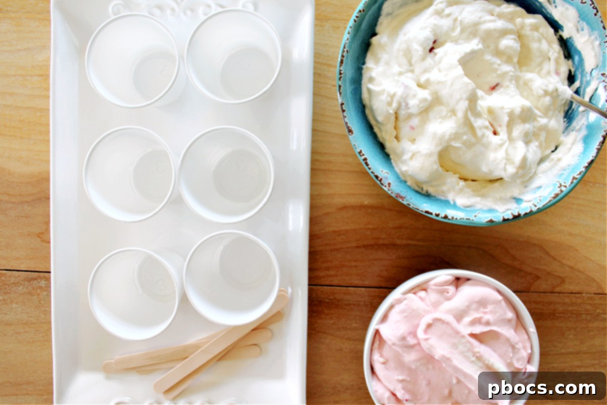 Blending strawberries with cream cheese for pink popsicle layer