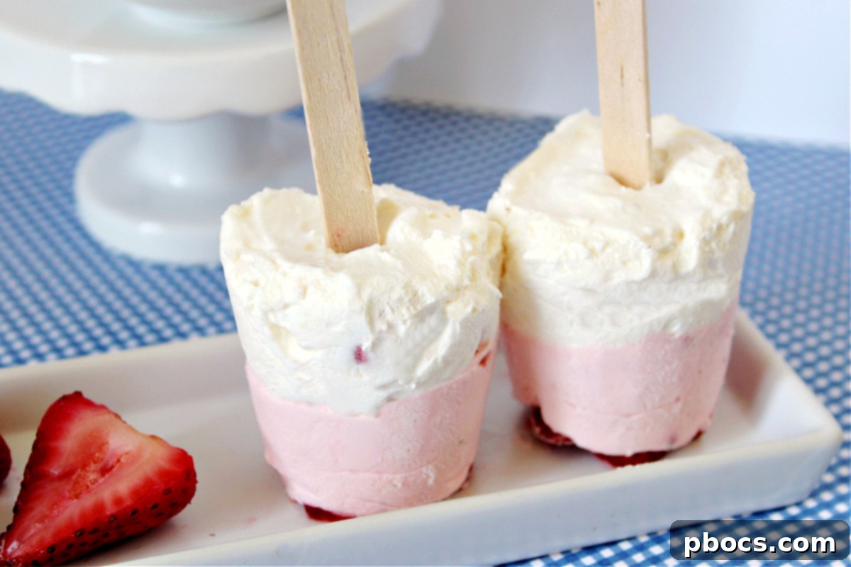 Ice cube tray with Keto Strawberry Cheesecake Popsicle mixture and sticks