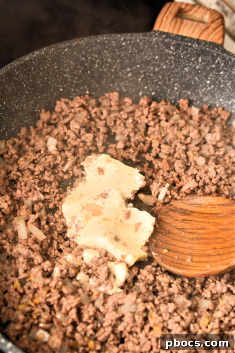 Step 2: Adding garlic and cream cheese to skillet mixture