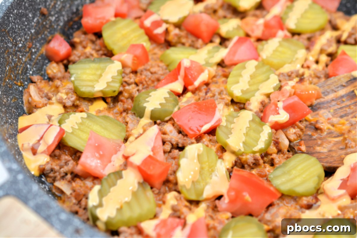 Scooping Keto Cheeseburger Skillet into freezer bags