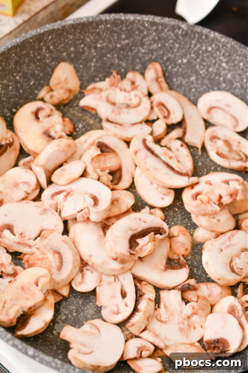 Comforting Keto Tuna Bake 17 Sautéed mushrooms in a skillet, tender and ready to be set aside.
