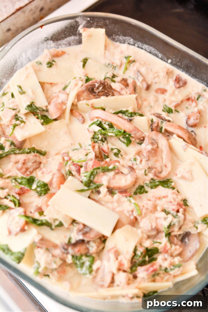 Comforting Keto Tuna Bake 24 The keto tuna noodle casserole mixture poured into a 9x9 baking dish, ready for the oven.