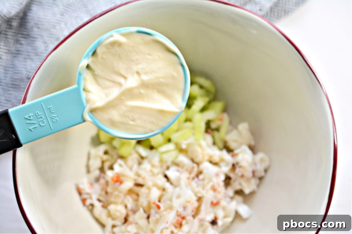 Step 3: Mixing all ingredients for the keto lobster salad.