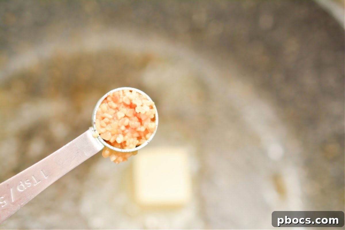 Ultimate Creamy Keto Garlic Shrimp 12 Minced garlic sautéing in melted butter in the skillet
