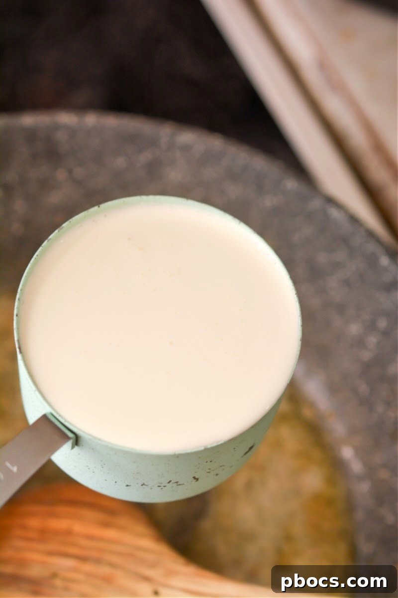 Ultimate Creamy Keto Garlic Shrimp 13 Whisking heavy cream, Italian seasoning, wine, and lemon juice for the sauce