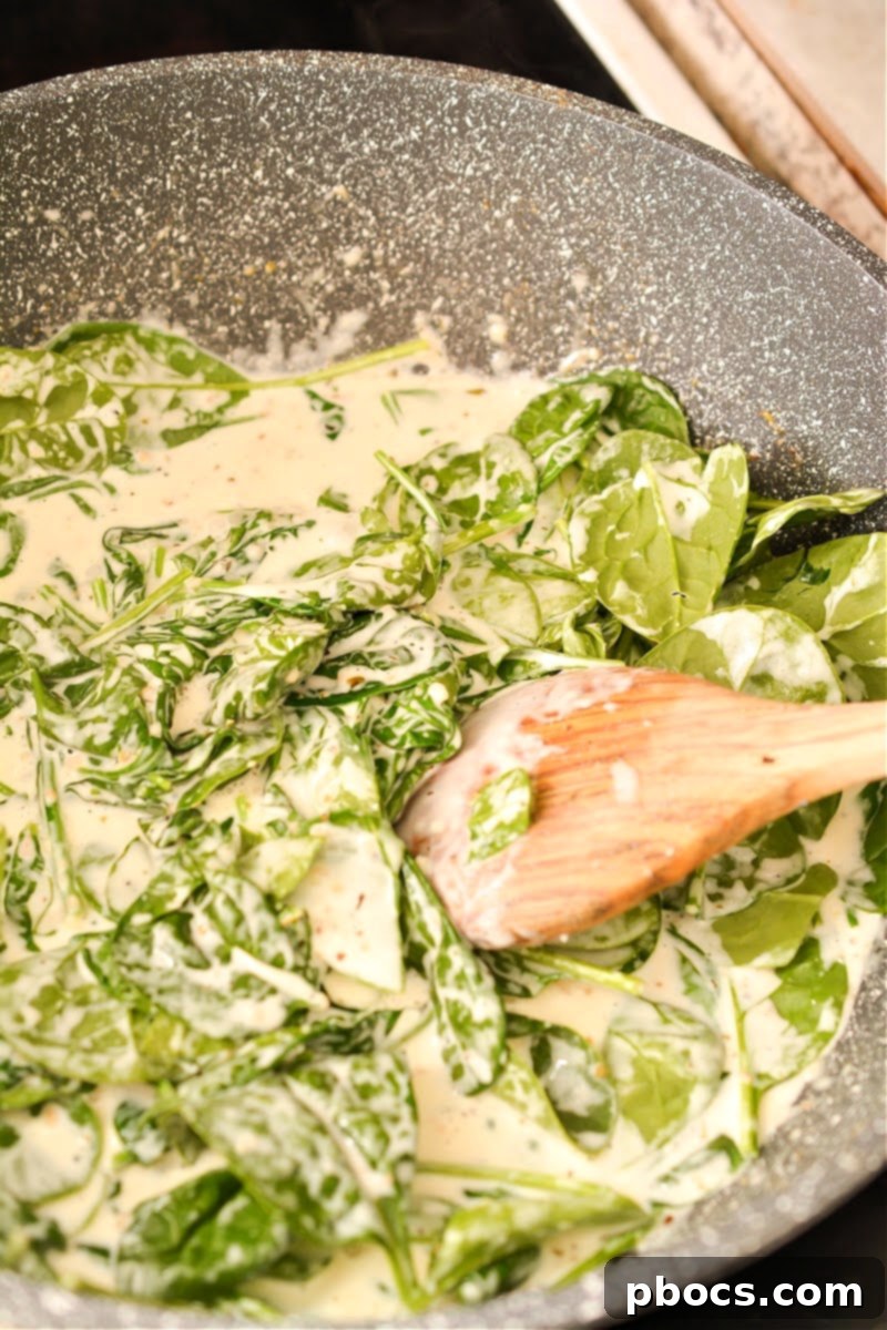 Ultimate Creamy Keto Garlic Shrimp 17 Spinach wilting into the creamy garlic sauce with Parmesan