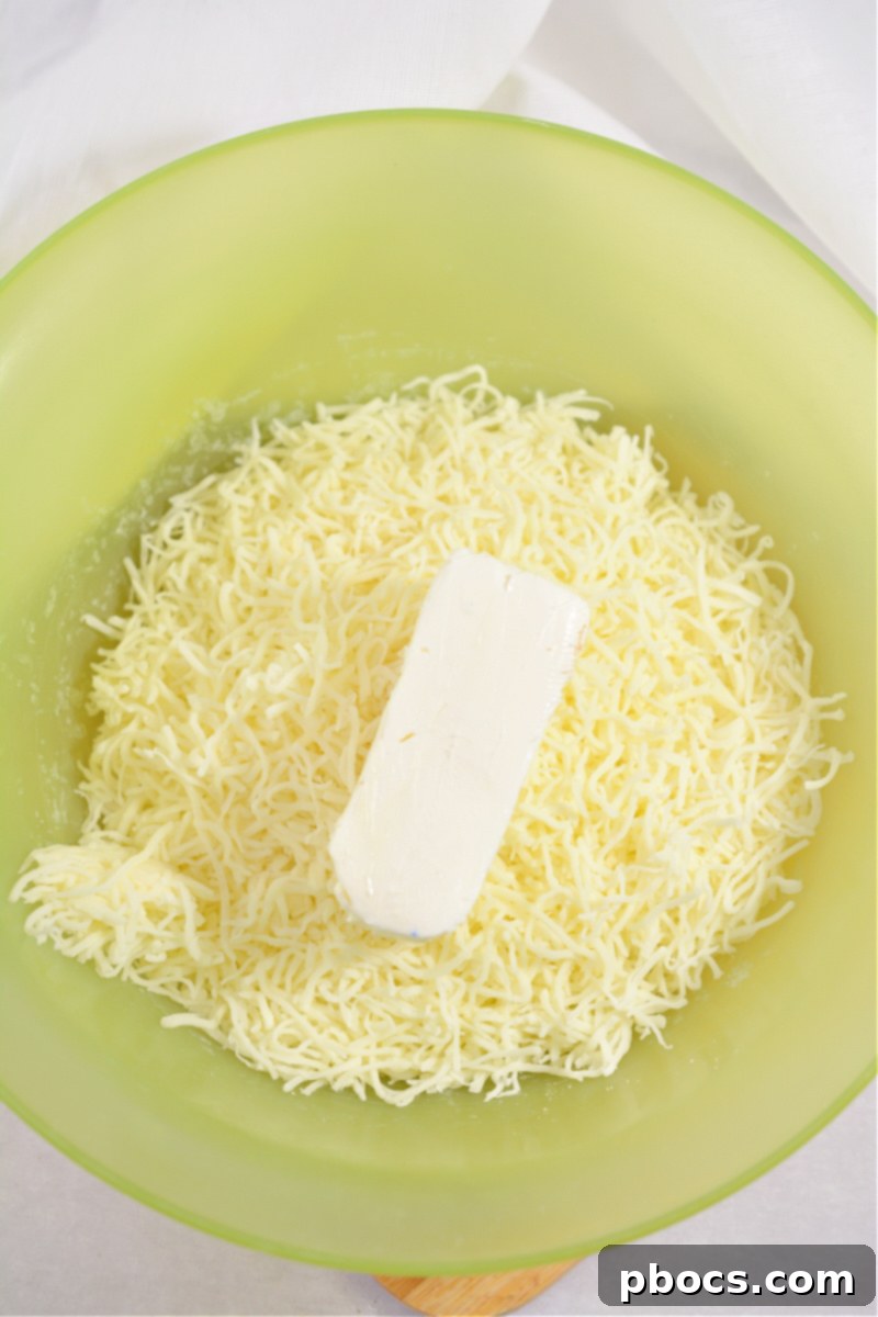 Melted cheese and cream cheese for keto fruit pizza crust