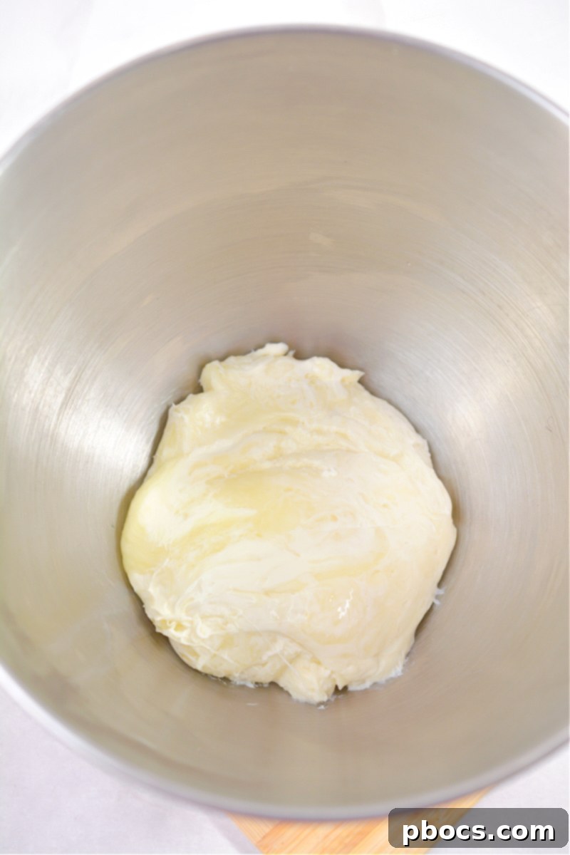 Mixing melted cheese for keto fruit pizza dough