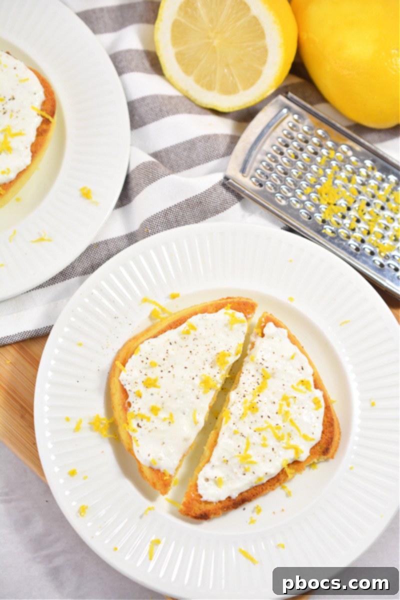 Delicious and easy Keto Ricotta Toast on a plate with fresh lemon zest and juice.