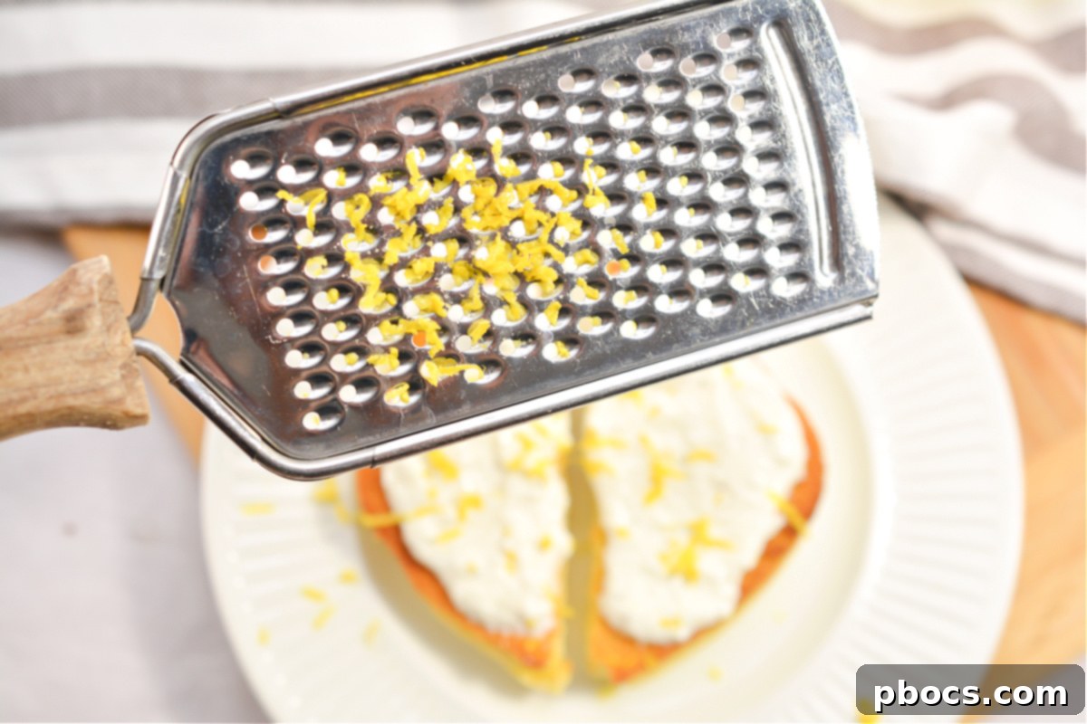 Serving Keto Ricotta Toast with fresh lemon zest on top.