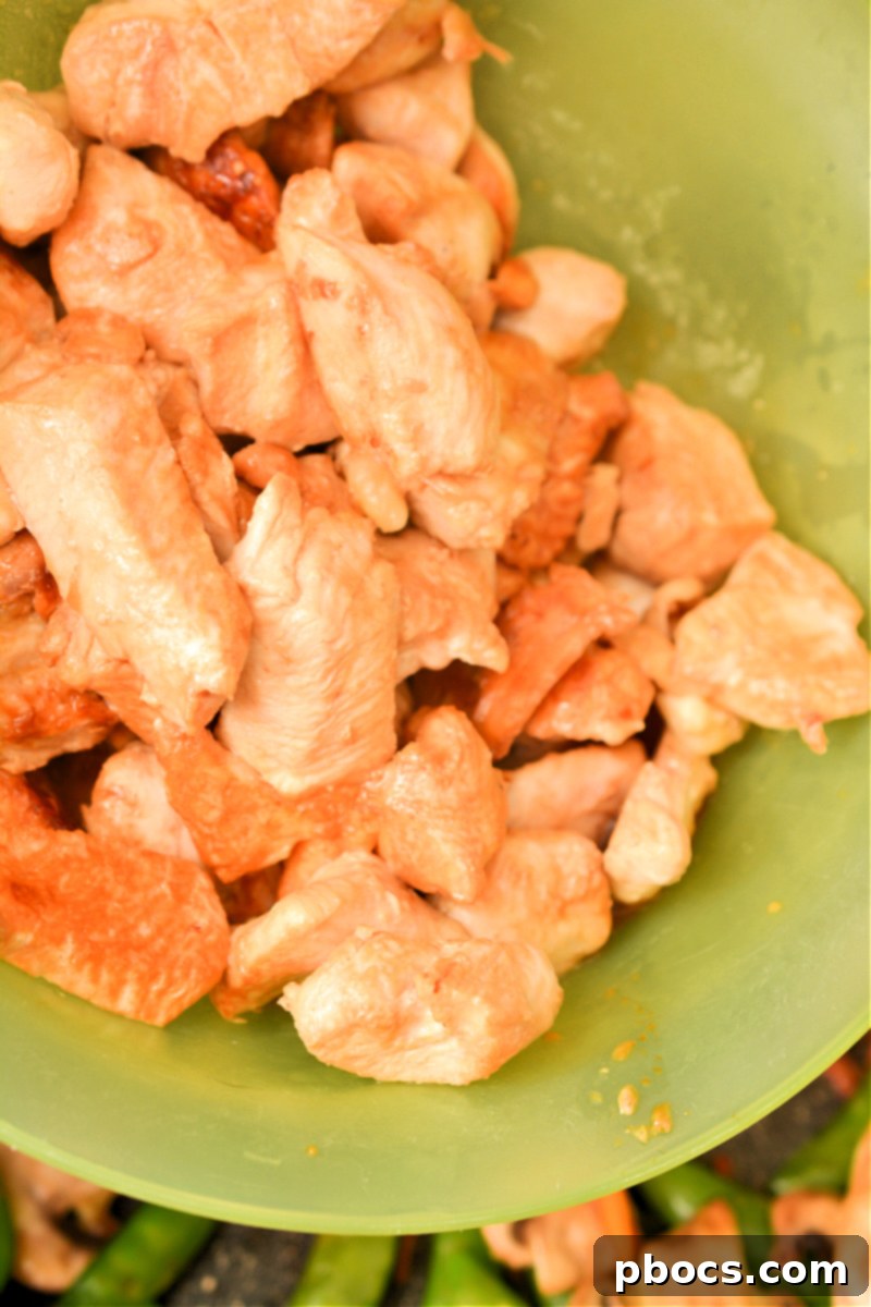 Keto Moo Goo Gai Pan Stir Fry 16 Step 8: Combining chicken and vegetables in the skillet.