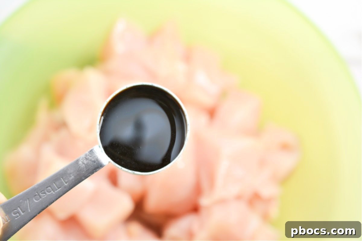 Keto Moo Goo Gai Pan Stir Fry 10 Step 2: Tossing chicken with rice vinegar and soy sauce.