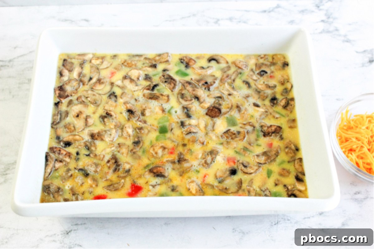 Savory Keto Veggie Morning Bake 13 Cooked bell peppers and mushrooms spread evenly in a 9x13 casserole dish