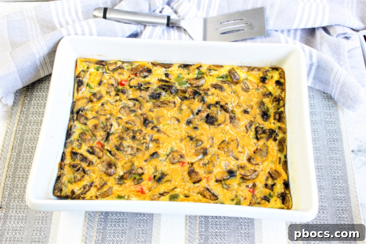 Savory Keto Veggie Morning Bake 3 Close-up of a generous slice of Keto Breakfast Bake, showing layers of eggs, cheese, and vegetables