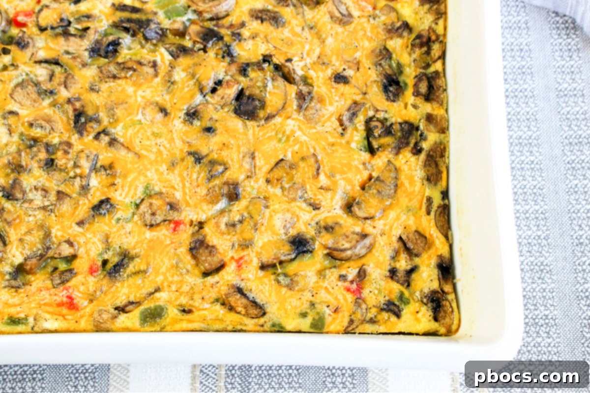Savory Keto Veggie Morning Bake 7 A portion of Keto Breakfast Bake on a white plate, showcasing the fluffy texture and colorful vegetables