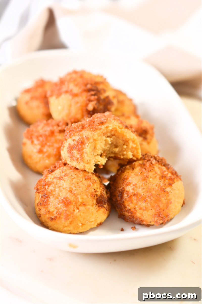 Keto Pumpkin Spice Donut Holes with a dusting of cinnamon sugar
