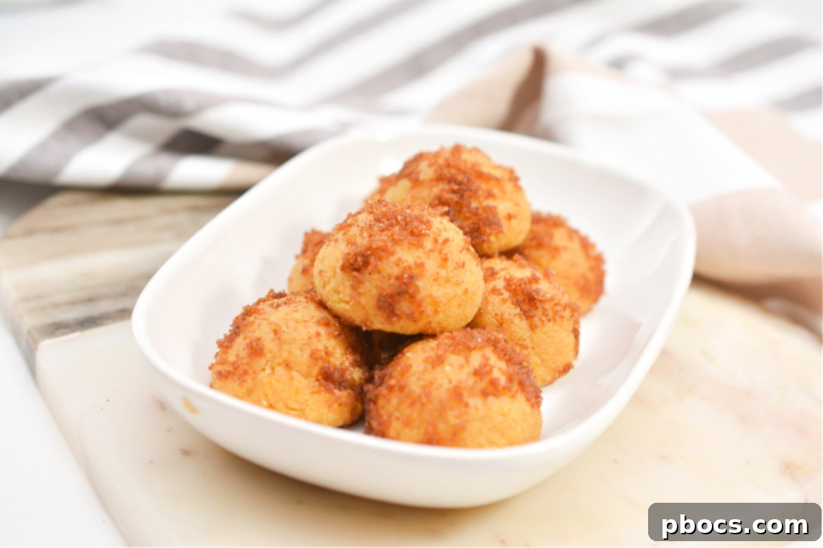 Close-up of baked Keto Pumpkin Spice Donut Holes on a cooling rack