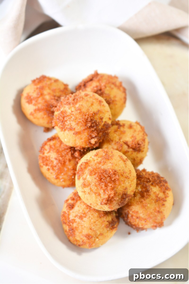 Hands rolling dough for Keto Pumpkin Spice Donut Holes