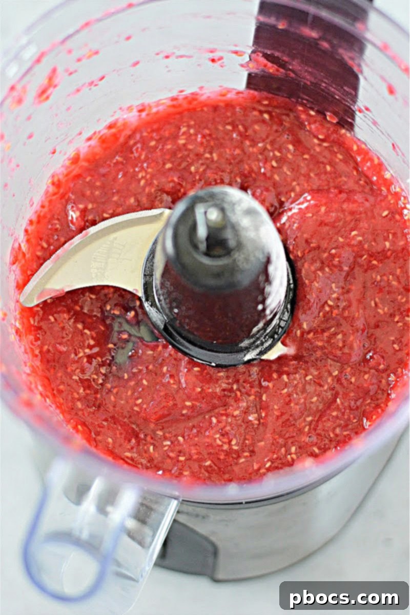 Smooth and vibrant raspberry sauce after blending in a food processor