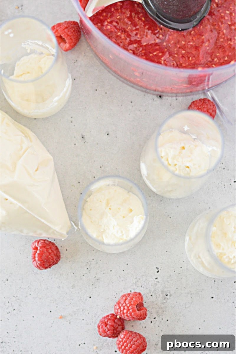 Piping fluffy cheesecake mixture into a glass serving cup