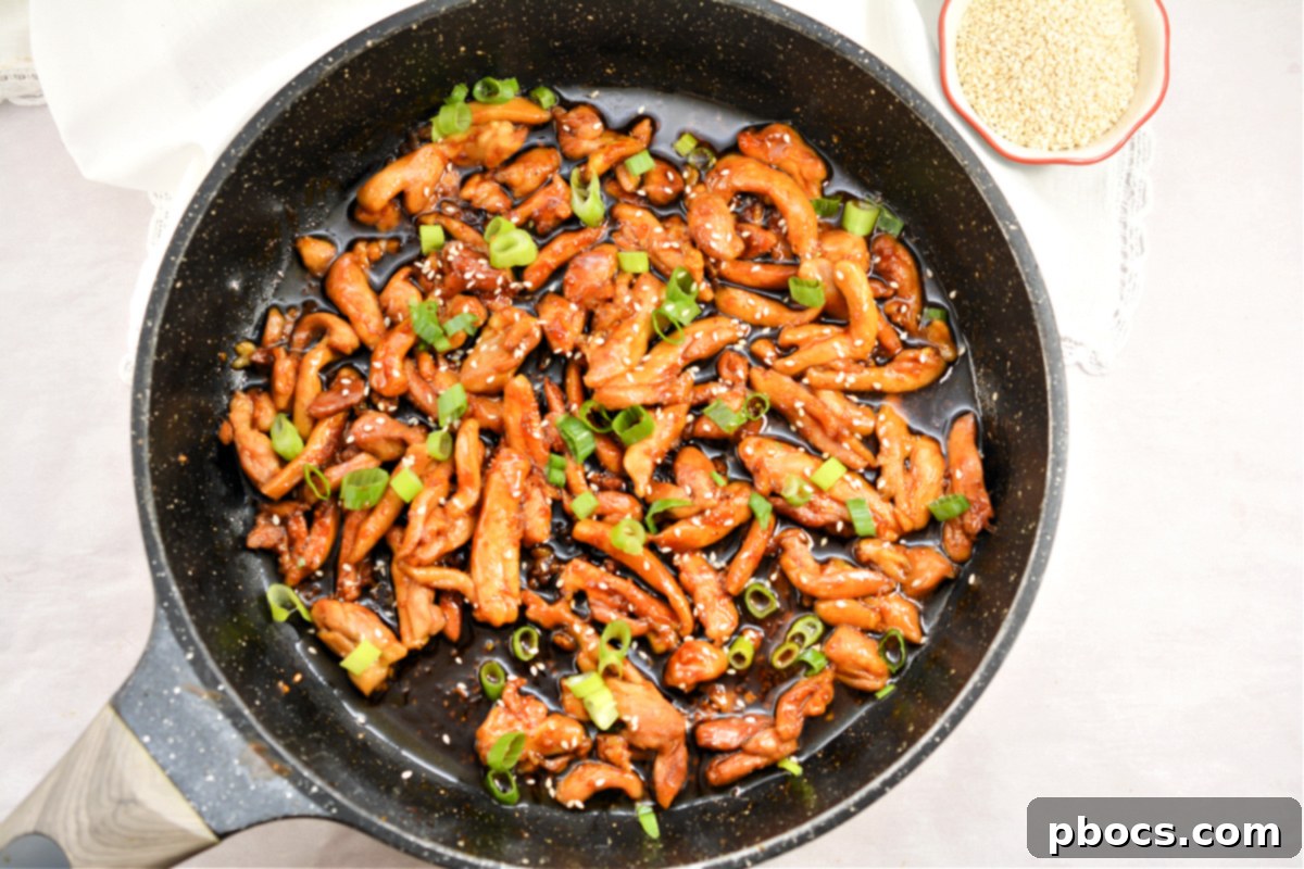 Sticky Keto Garlic Chicken being cooked in a slow cooker, indicating a convenient meal prep option.