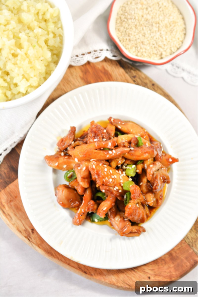 Airtight glass container filled with Sticky Keto Garlic Chicken, neatly stored for meal prep.