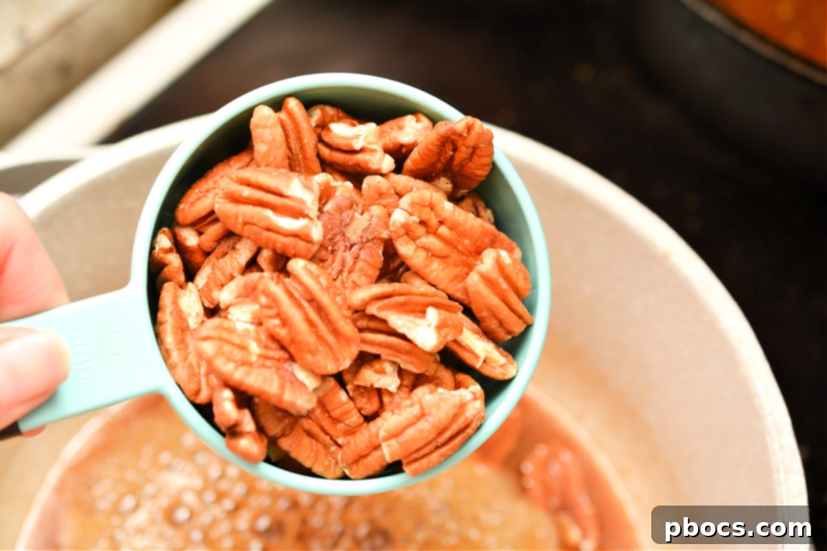 Stirring pecans into the praline mixture