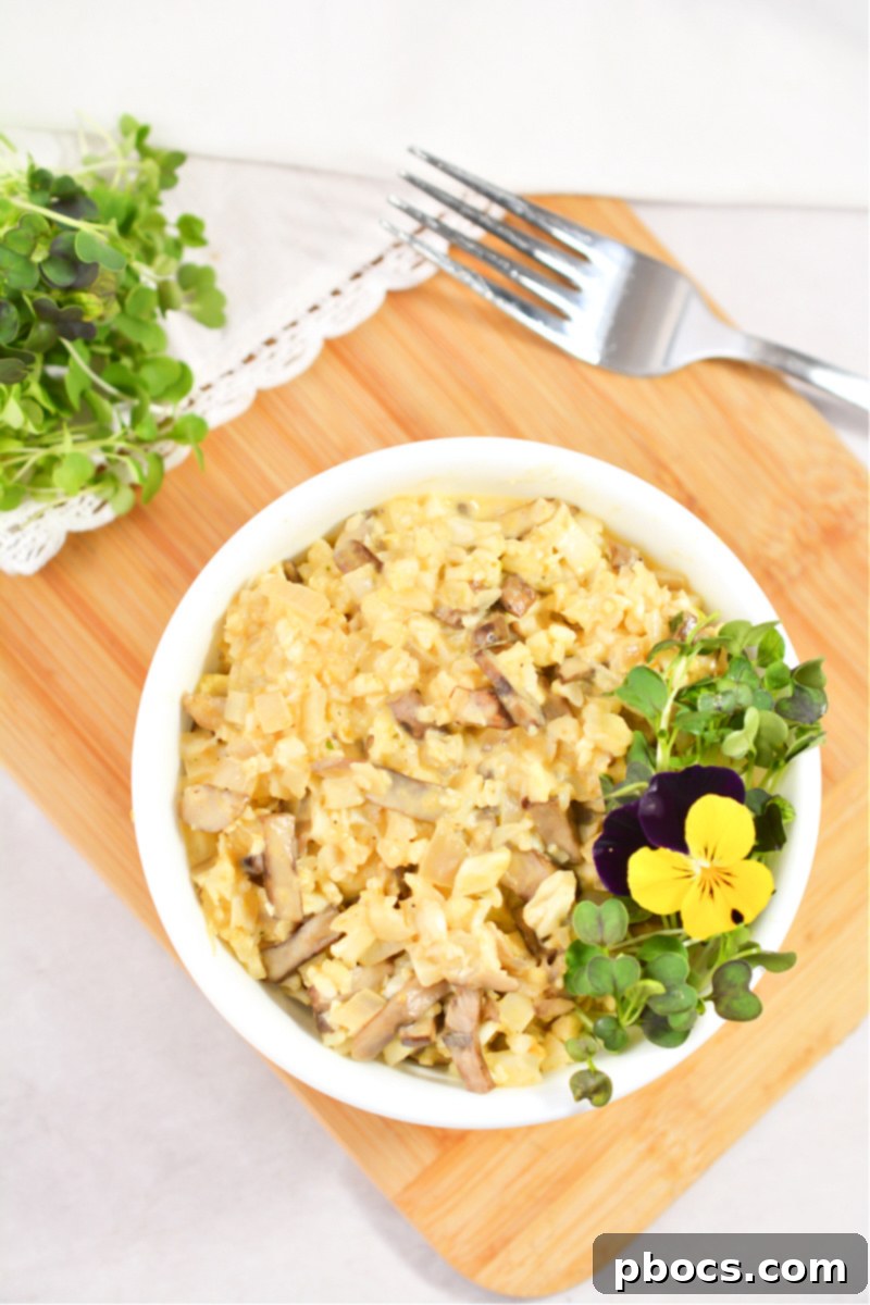 Creamy Keto Mushroom and Pumpkin Risotto made with Cauliflower Rice, garnished with edible pansies